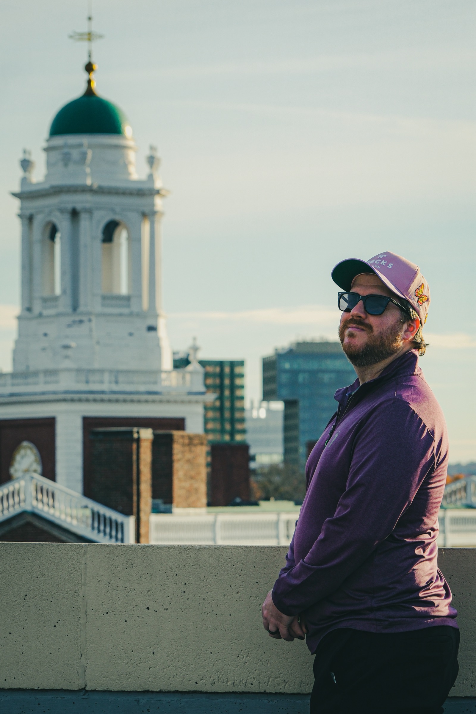 Portrait - man on rooftop overlooking city church dome and skyline