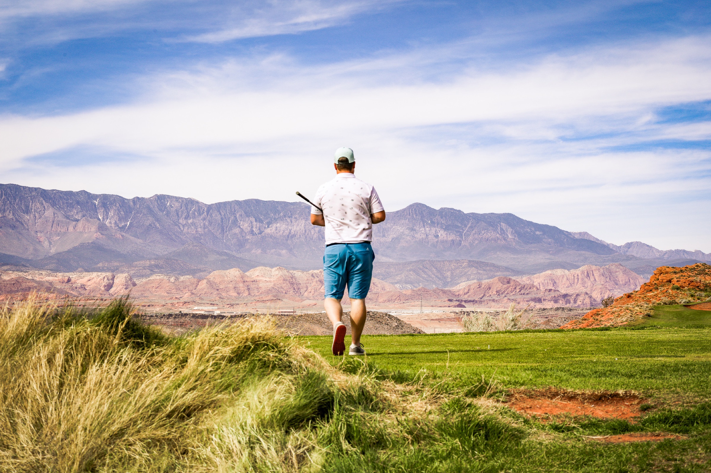 Lifestyle - golfer walking into desert landscape